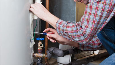 Worker fixing hot water heater